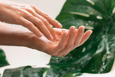 Closeup of wet female hands with moisturized oily skin